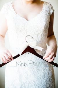 Bride holding hanger pic