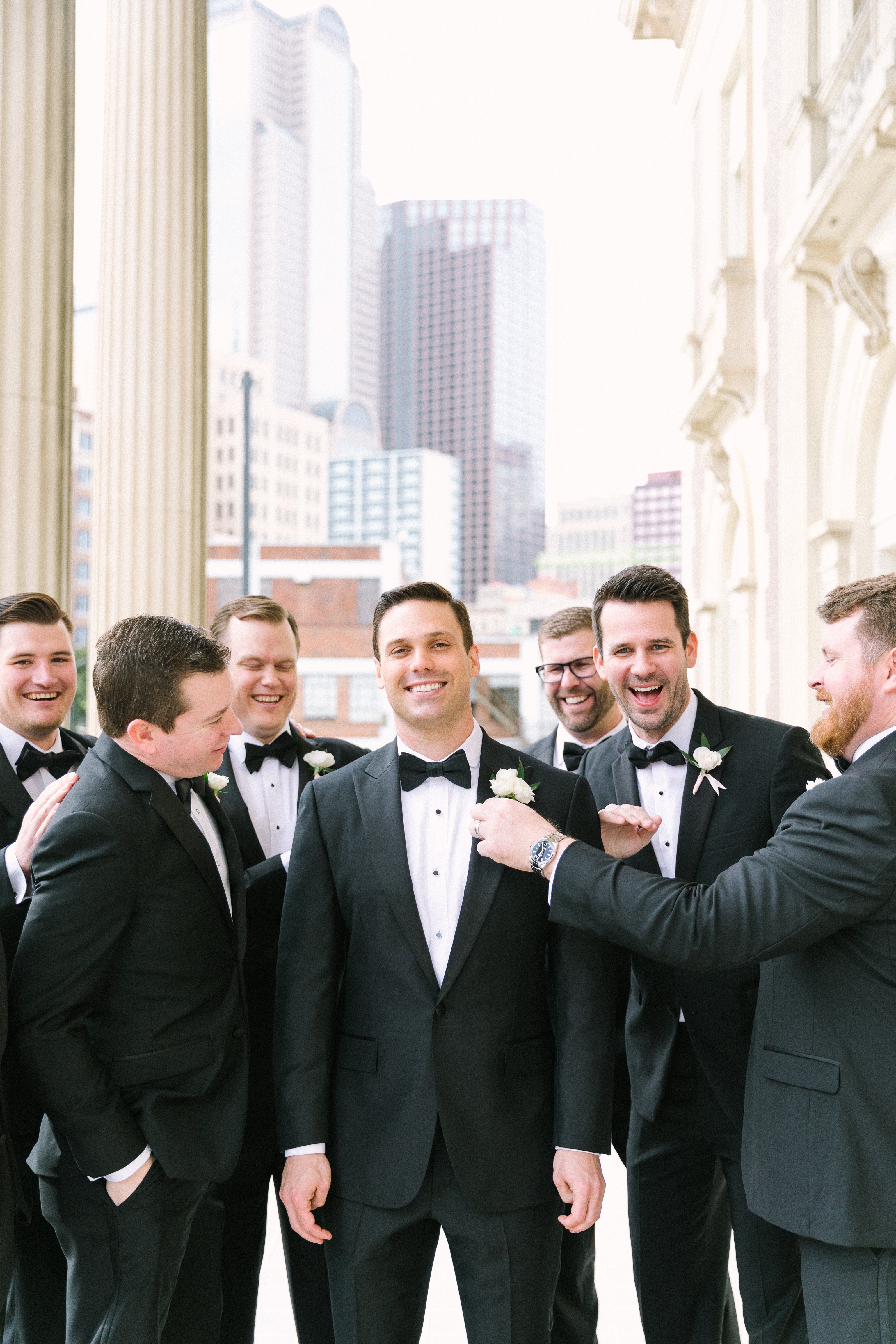 Handsome groom with his groomsmen outside of the Scottish Rite Cathedral before his wedding