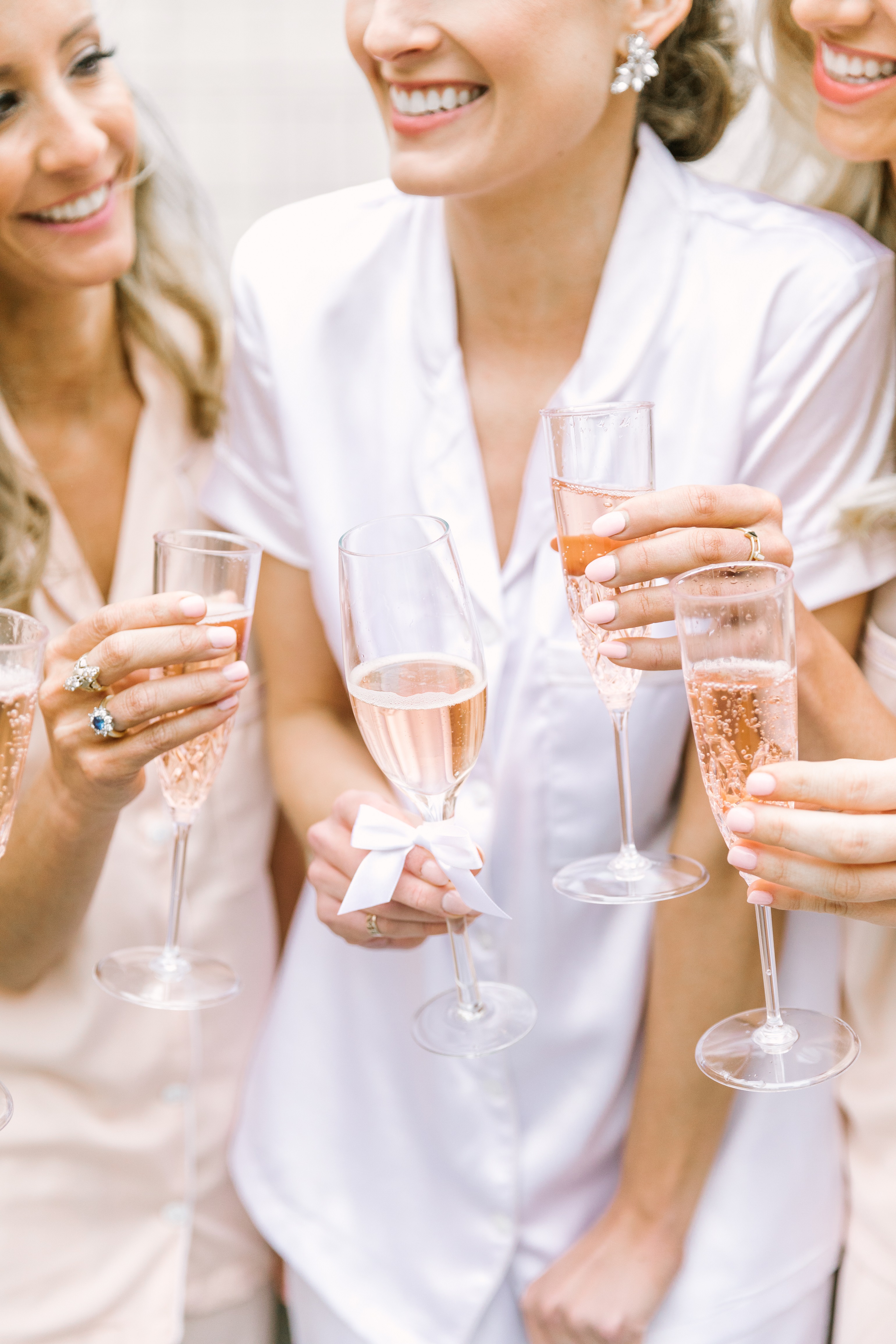 Bride and Bridesmaids celebrating with rose champagne